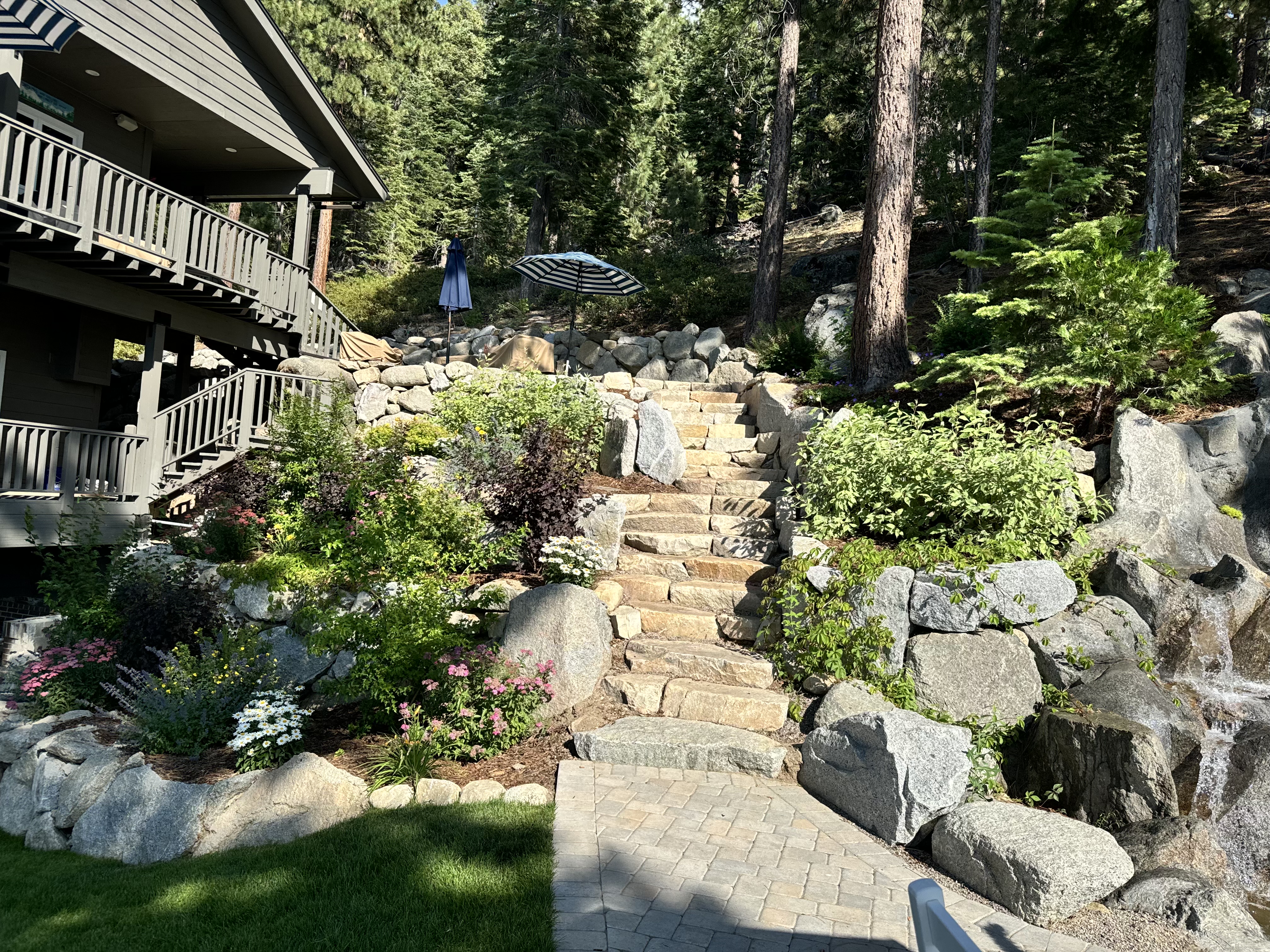 Complete Tahoe landscape design with stone stairs, boulders, lawn, planting beds, and water feature